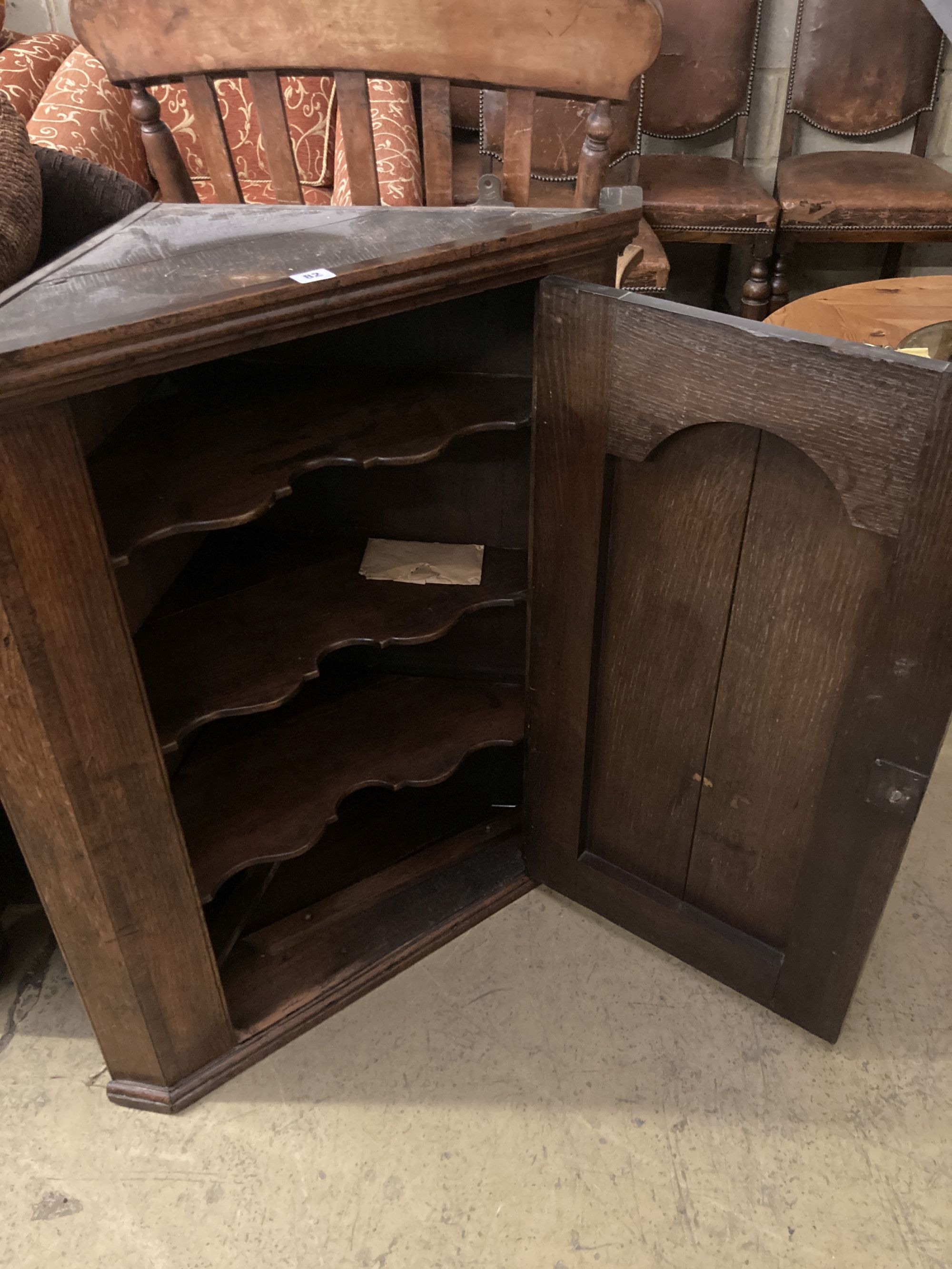 A George III oak hanging corner cabinet, width 77cm, depth 42cm, height 93cm